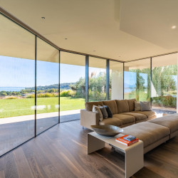 TV room at Villa Belvedere with large windows and lake views