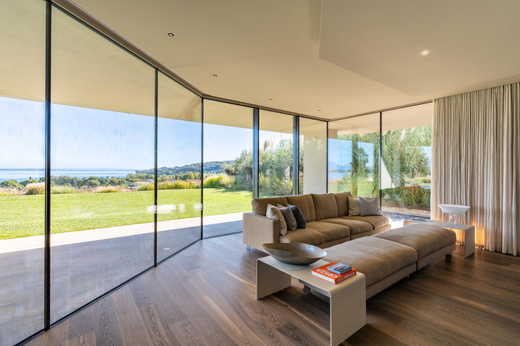 TV room at Villa Belvedere with large windows and lake views