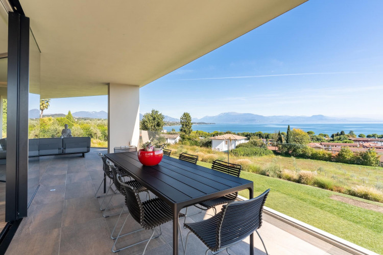 Main terrace at Villa Belvedere with large dining table and lake view