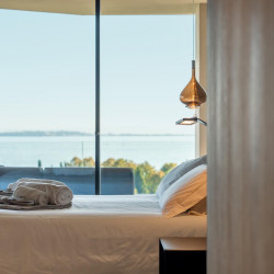 Master bedroom at Villa Belvedere with king-size bed and lake