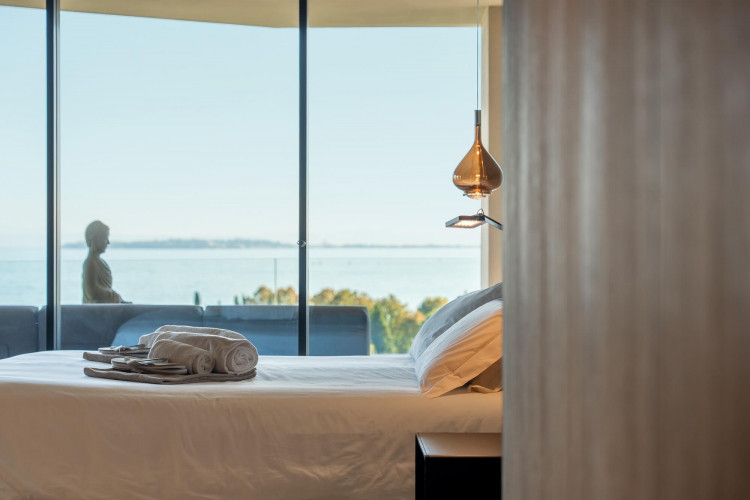 Master bedroom at Villa Belvedere with king-size bed and lake