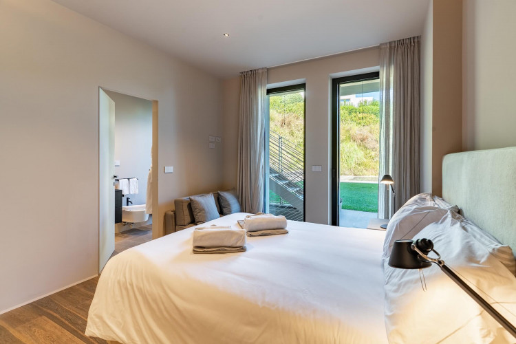 Bedroom at Villa Belvedere with balcony and partial lake view