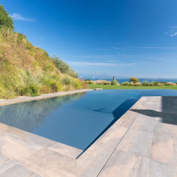 Pool area at Villa Belvedere with loungers and lake view