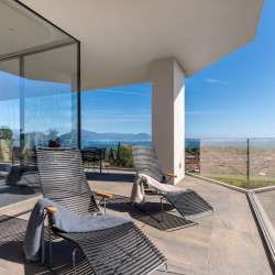 Terrace area at Villa Belvedere with loungers and lake view