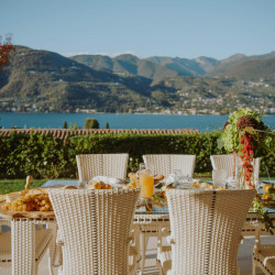 Outdoor dining area with panoramic lake views at Villa Preone, Lake Garda