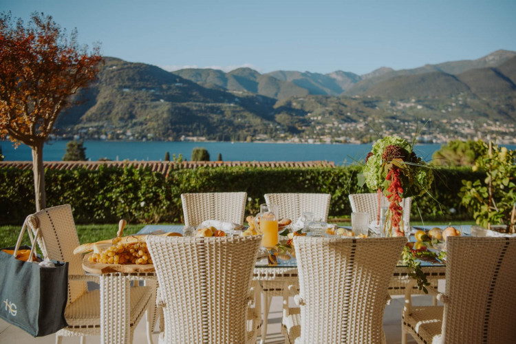 Outdoor dining area with panoramic lake views at Villa Preone, Lake Garda