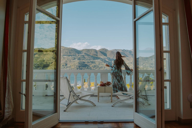 Stylish bedroom with lake view terrace at Villa Preone, Salò